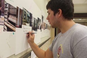 Stephen Kreller leaves a comment on the Katrina exhibit displayed in Walker Hall. 