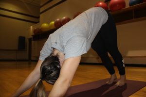 Student, Maddie McCannon, show cases her best yoga moves.