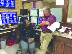 Tom Torregrossa speaks to Linda Ross at the front desk of the UPD station during his first week as Director of Police.