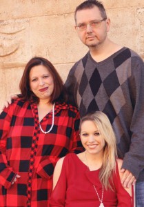 Carissa Sawyer and her parents smile during a holiday photo session.