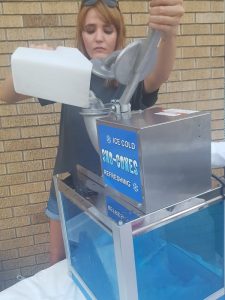 Sarah Wheat pouring ice to make snow cones